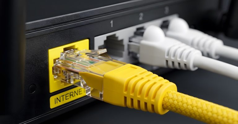 Close Up Yellow Ethernet Cable Plugged into Internet Port on Router with Multiple LAN Connections
